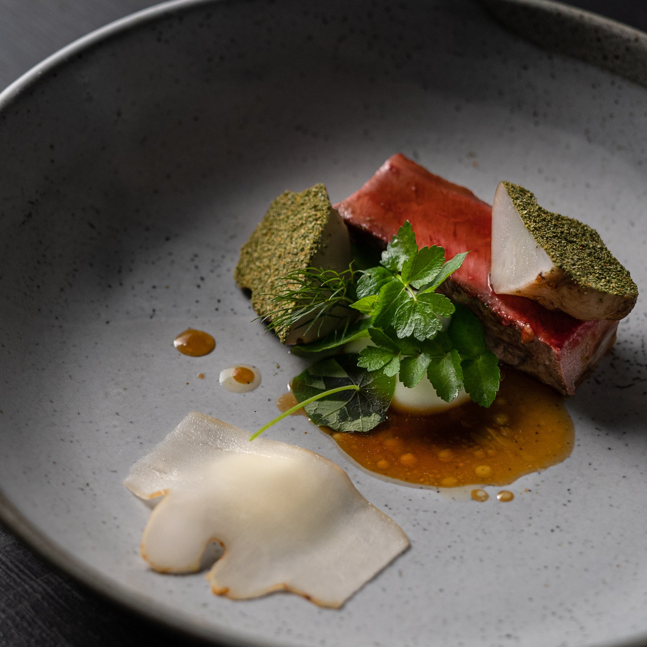 A close up shot of a plate of food including seared fish and cilantro from The Restaurant at Wills Domain, the epicurean heart of Margaret River.