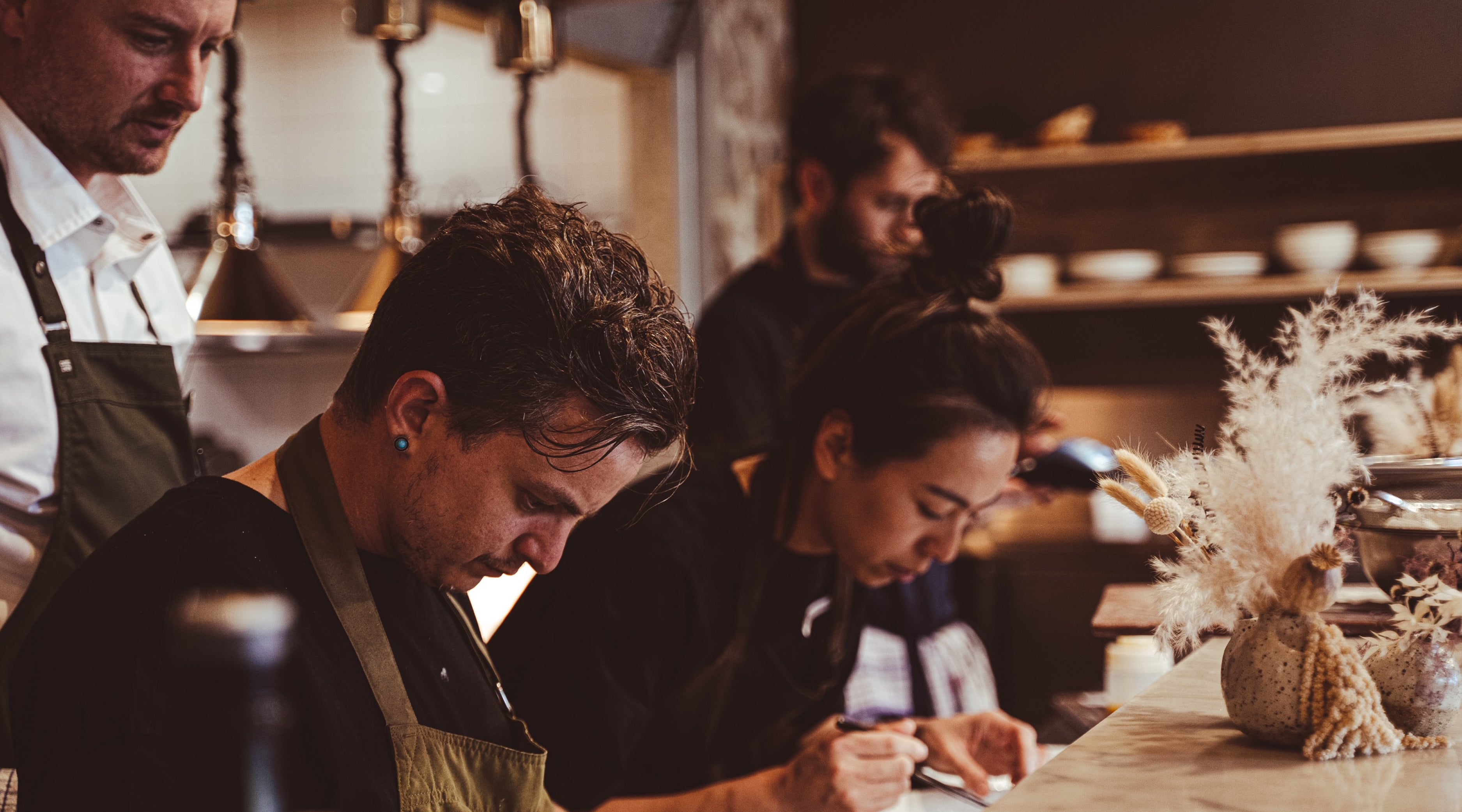 The Restaurant team at Wills Domain in action in the kitchen creating the award-winning fine-dining experience that makes this restaurant a foodie destination in Margaret River.