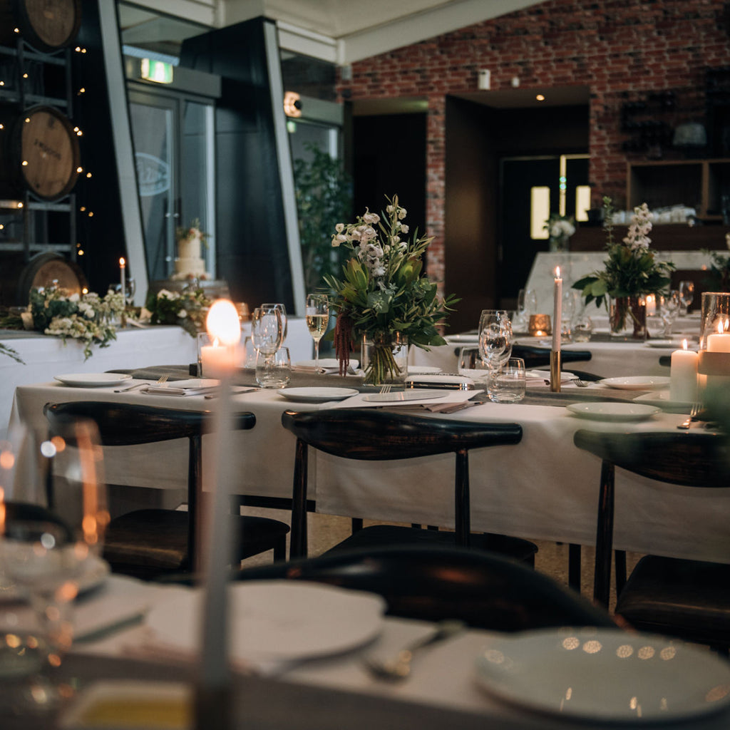 Wills Domain's The Restaurant set for a private function complete with soft candlelight and floral arrangements. The Restaurant is a popular Margaret River wedding and events venue.
