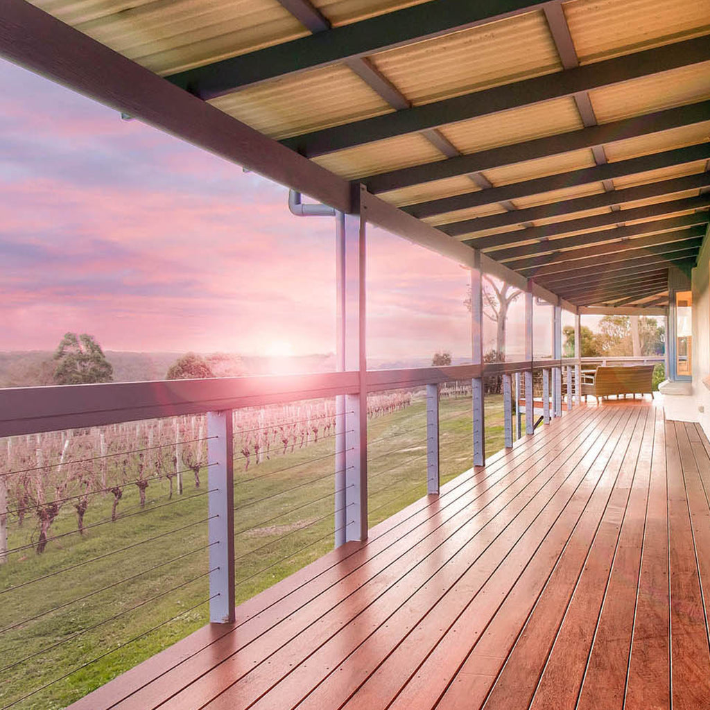 The deck at the Wills Domain homestead accommodation is the perfect place to soak up the sunset views over the vines.